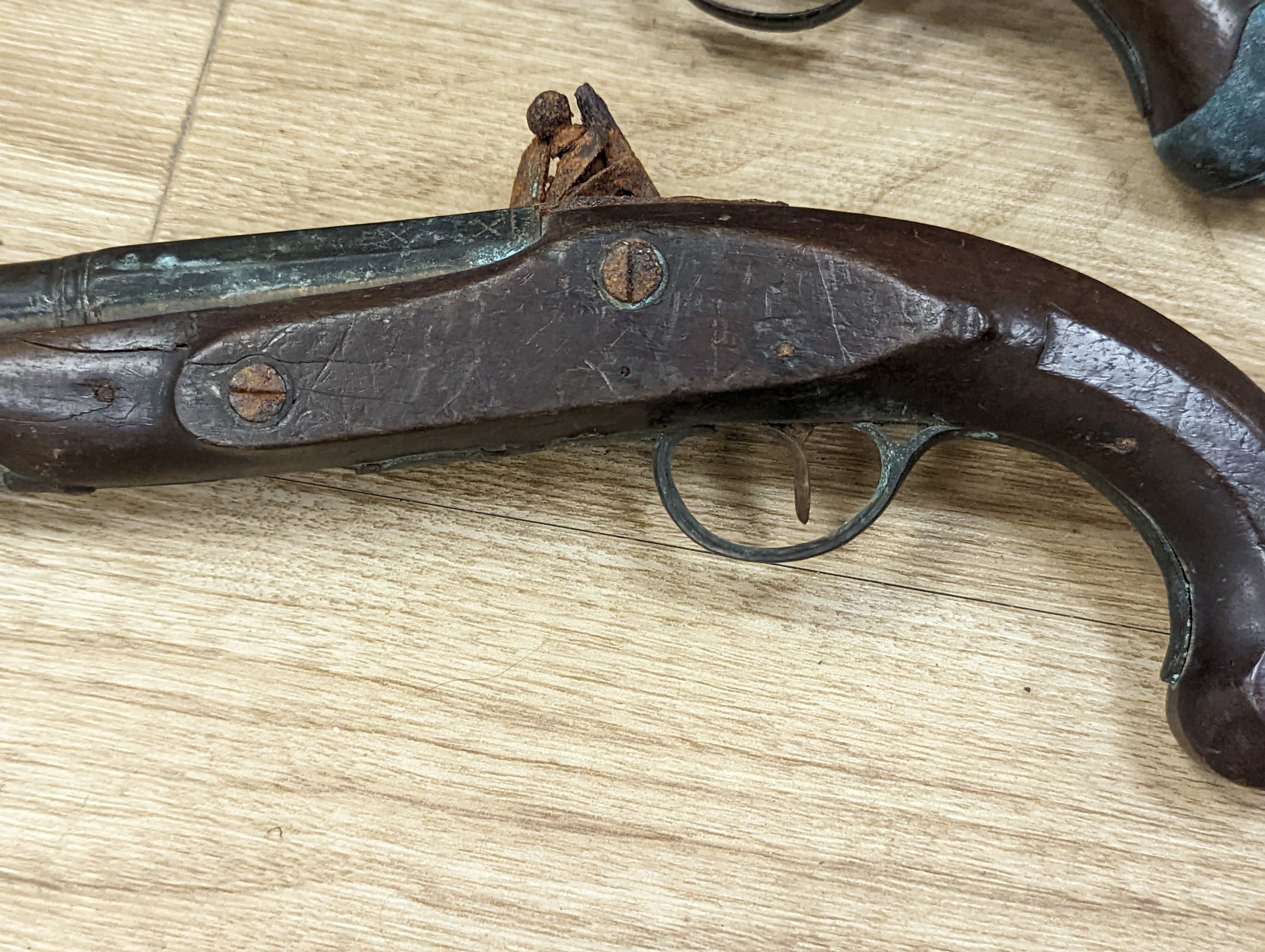 Two 19th century flintlock pistols and a pocket pistol, largest 40 cms long.